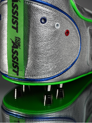 Detail of a custom blue, silver, and green dopp kit shaped like a soccer cleat with a resting on a soccer ball. More info at haleonassist.com.