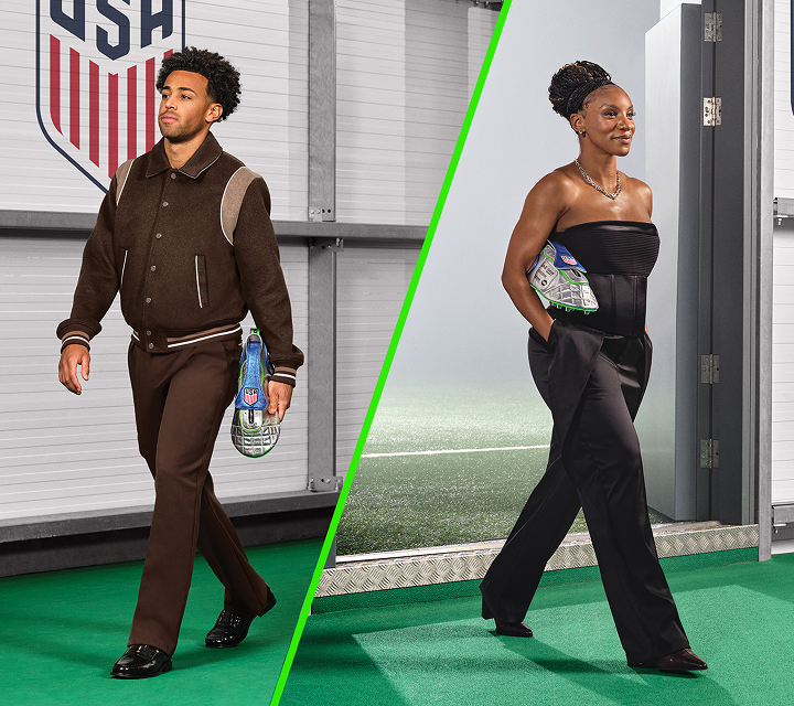 U.S. Soccer players Tyler Adams and Crystal Dunn walk with a custom dopp kit shaped like a soccer cleat.