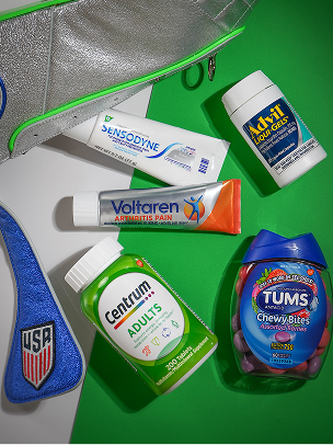 A custom blue, silver, and green dopp kit shaped like a soccer cleat laying next to Centrum, TUMS, Advil, Sensodyne, and Voltaren products. More info at haleonassist.com. Disclaimer says Some products may contain NSAIDs and/or Acetaminophen and should not be taken together. Please review labels and use as directed.