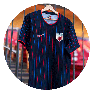 A hanging, blue soccer jersey with the U.S. Soccer emblem on the chest.