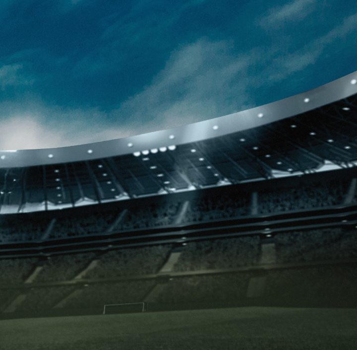 A view inside an empty stadium, looking up at the sky and stands.